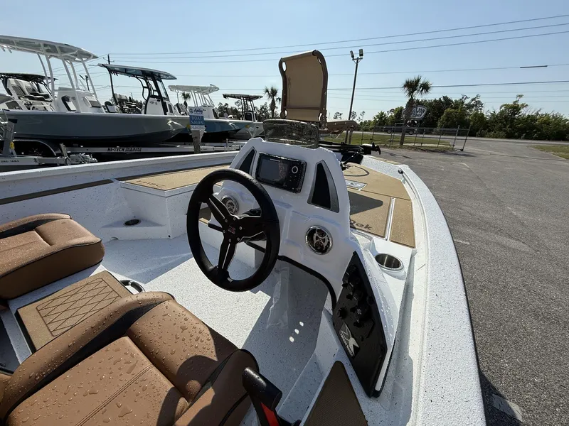 Slide: The Image of 2025 Xpress Hyper-Lift H18 Crappie boat interior with steering wheel and seating. - 3