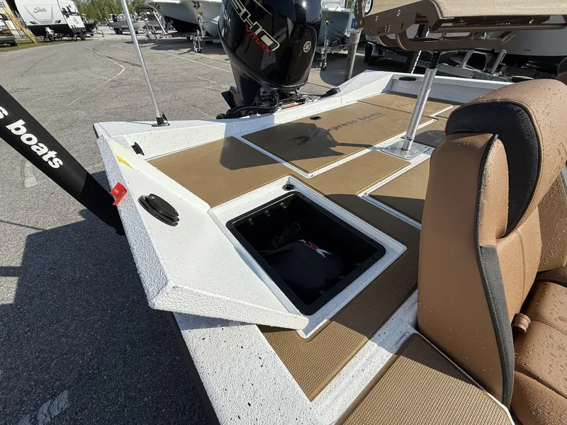 Slide: The Image of 2025 Xpress Hyper-Lift H18 Crappie boat with open storage compartment and Yamaha engine. - 6