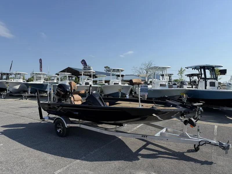 Slide: The Image of 2025 Xpress Hyper-Lift Series H18 bass boat on trailer in parking lot. - 1