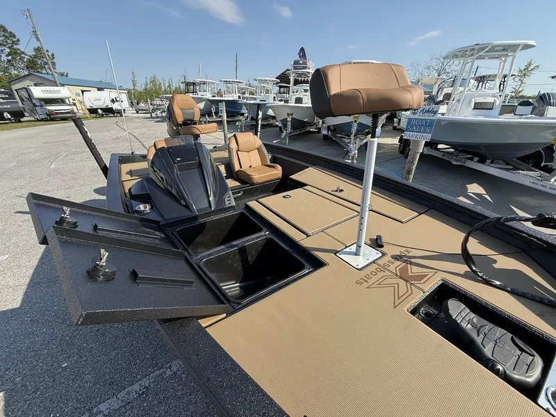 Slide: The Image of 2025 Xpress Hyper-Lift Series H18 bass boat with open storage compartments and seating. - 6
