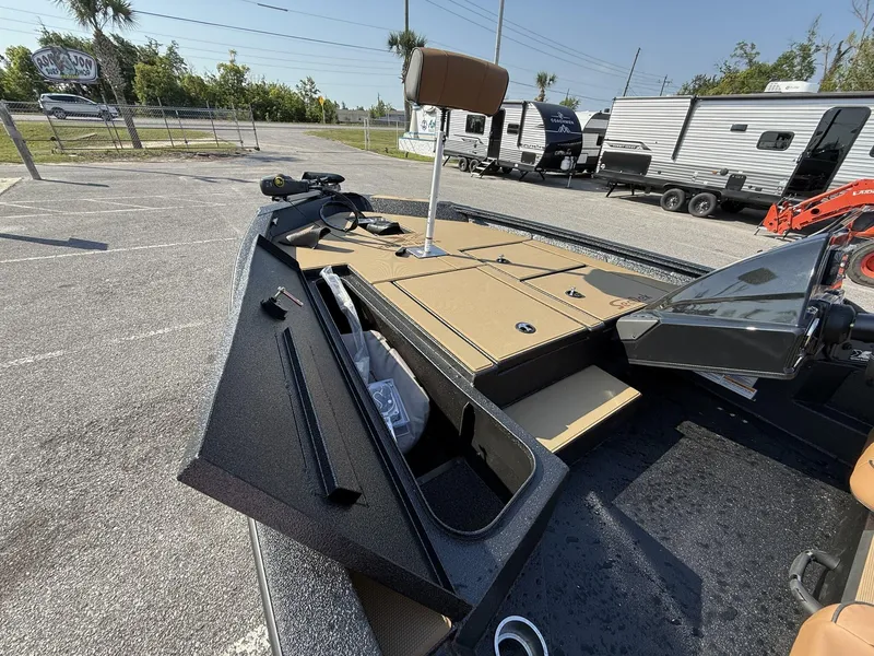 Slide: The Image of 2025 Xpress Hyper-Lift Series H18 bass boat with open storage compartments in a parking lot. - 7