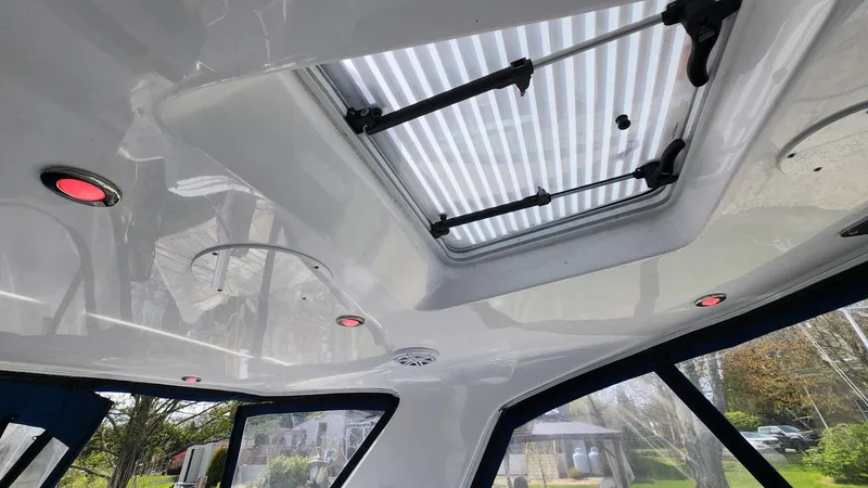 Slide: The Image of 2021 Monterey 335 Sport Yacht interior ceiling with skylight and recessed lighting. - 10