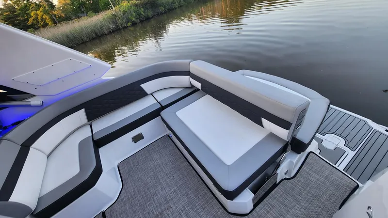 Slide: The Image of 2021 Monterey 335 Sport Yacht interior with sleek seating by the water. - 11
