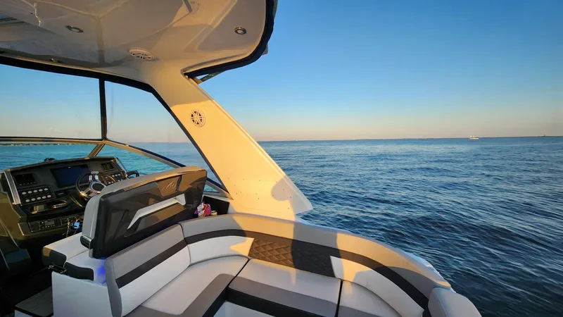 Slide: The Image of 2021 Monterey 335 Sport Yacht interior with ocean view at sunset. - 16