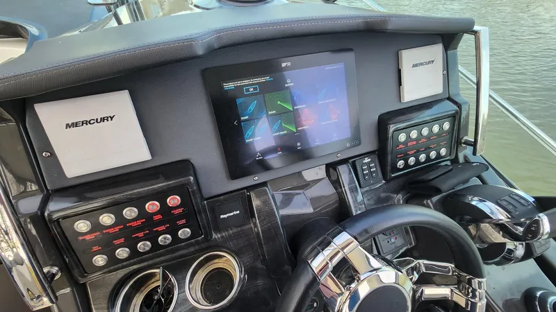 Slide: The Image of Control panel of 2021 Monterey 335 Sport Yacht with Mercury displays and steering wheel. - 19