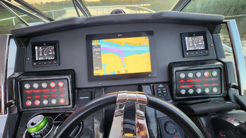Slide: The Image of Dashboard of a 2021 Monterey 335 Sport Yacht with navigation display and controls. - 23