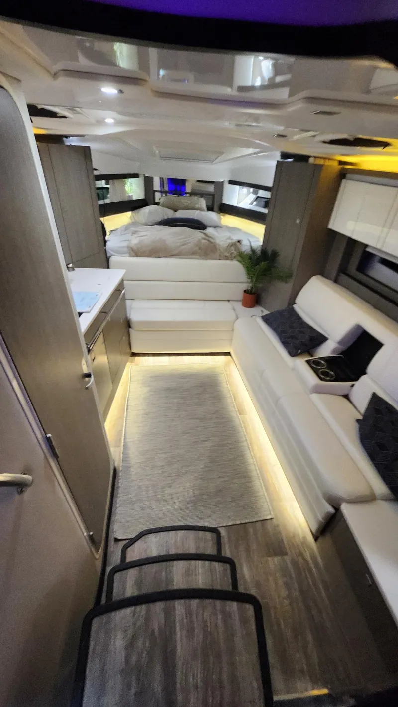 Slide: The Image of Interior of 2021 Monterey 335 Sport Yacht with modern furnishings and ambient lighting. - 25