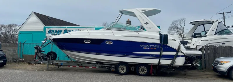 Slide: The Image of 2021 Monterey 335 Sport Yacht on trailer, parked outdoors. - 32