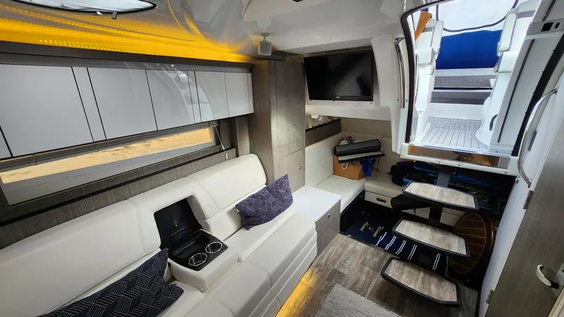 Slide: The Image of Interior of 2021 Monterey 335 Sport Yacht with modern seating and entertainment area. - 34
