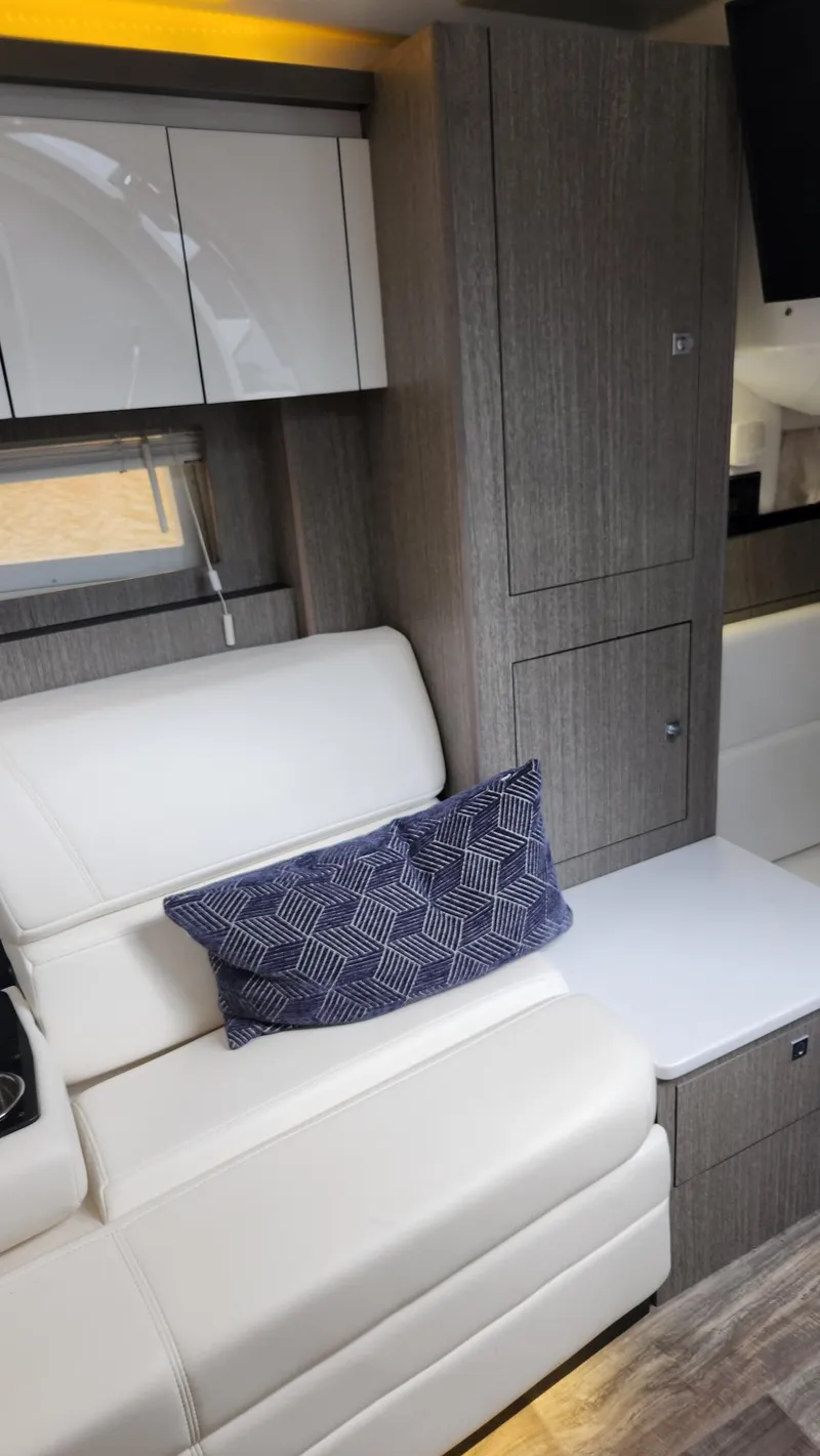 Slide: The Image of Interior of 2021 Monterey 335 Sport Yacht with white seating and modern cabinetry. - 36