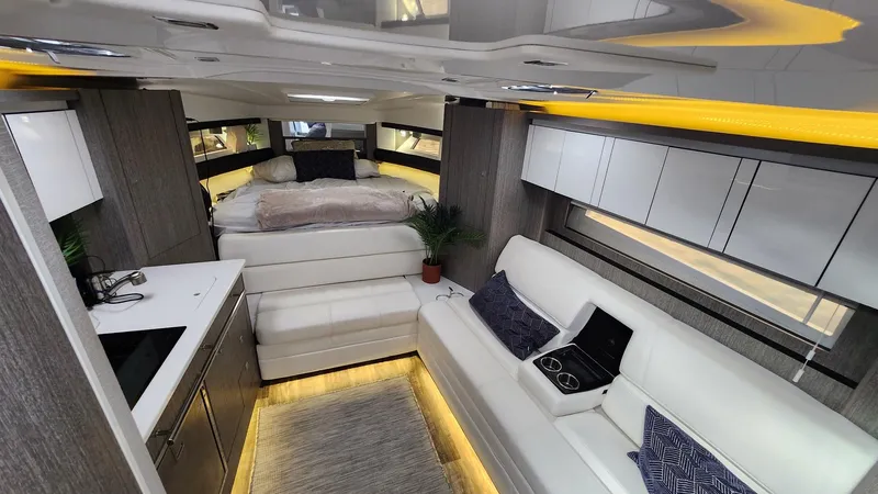 Slide: The Image of Interior of 2021 Monterey 335 Sport Yacht with modern seating and ambient lighting. - 38