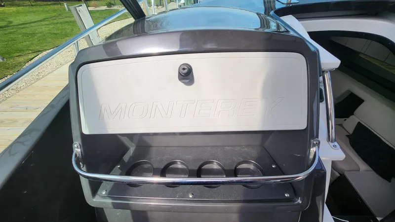 Slide: The Image of 2021 Monterey 335 Sport Yacht interior with cup holders and sleek design. - 39