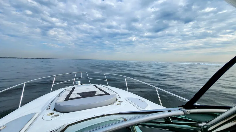 Slide: The Image of 2021 Monterey 335 Sport Yacht cruising on calm ocean under cloudy sky. - 6