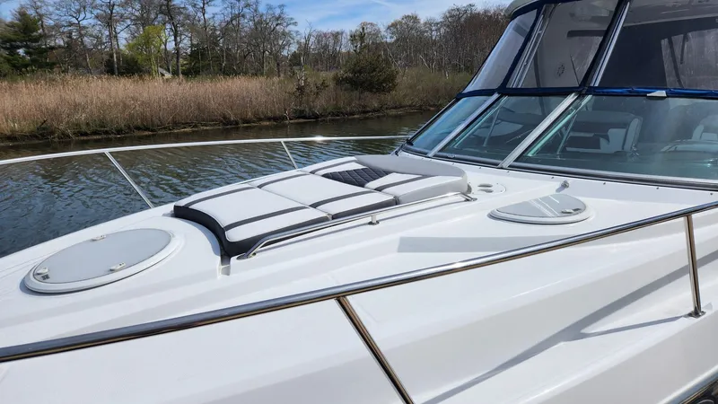 Slide: The Image of 2021 Monterey 335 Sport Yacht on a serene river with lush trees. - 9