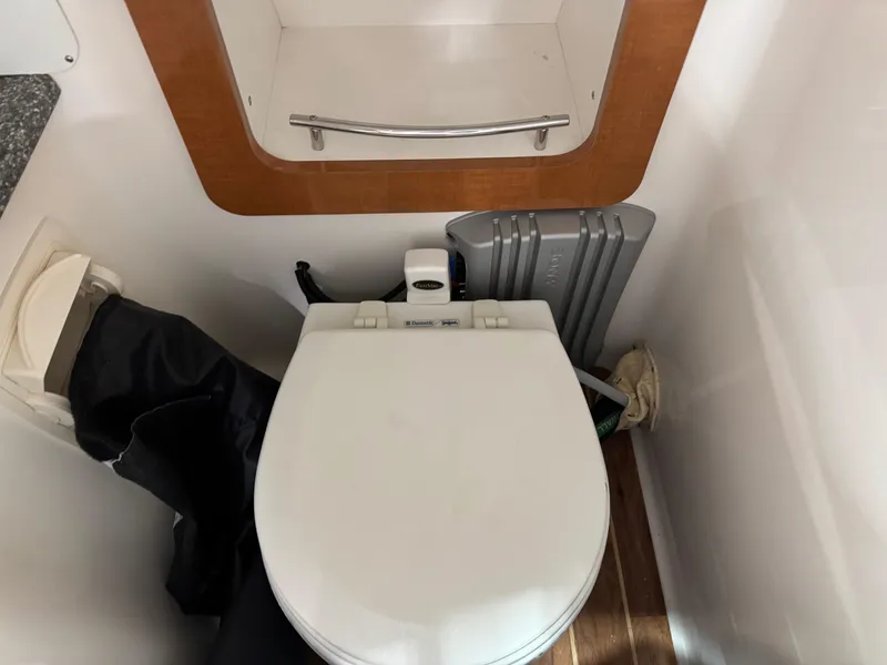 Slide: The Image of 2007 Chaparral 276 SSX boat bathroom with toilet and storage shelf. - 14