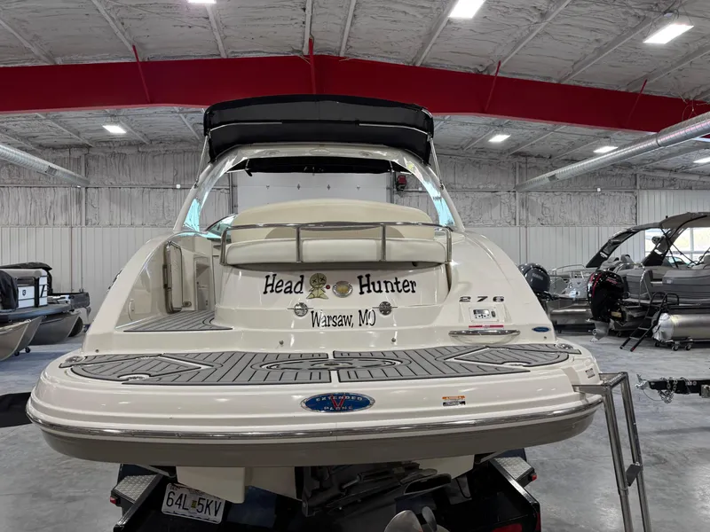 Slide: The Image of 2007 Chaparral 276 SSX boat in a warehouse, rear view with "Head Hunter" text. - 5