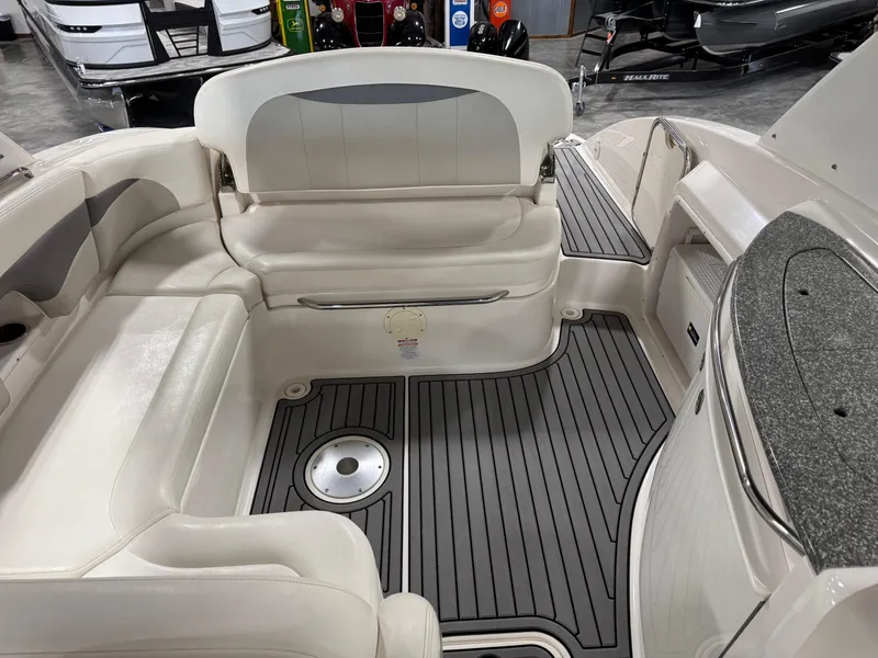 Slide: The Image of 2007 Chaparral 276 SSX boat interior with white seating and gray flooring. - 9