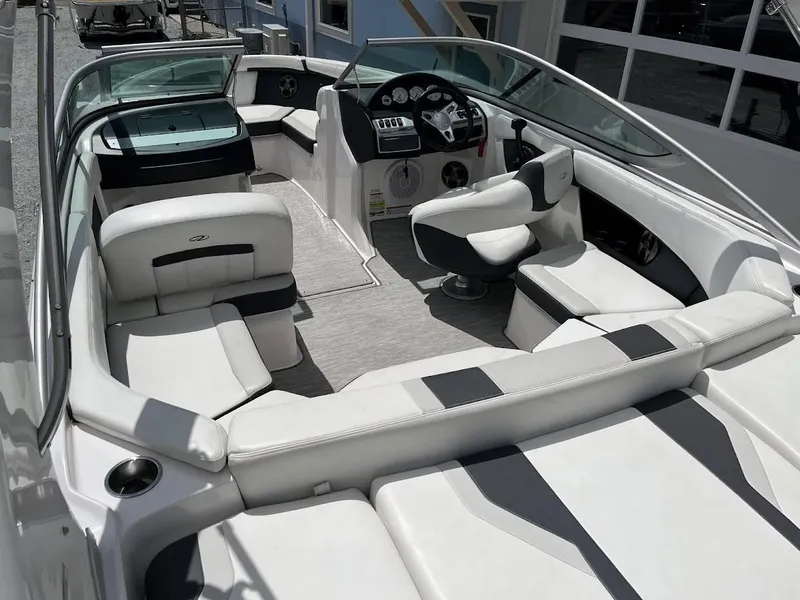 Slide: The Image of 2016 Regal 2000 ESX boat interior with white seating and modern dashboard. - 11