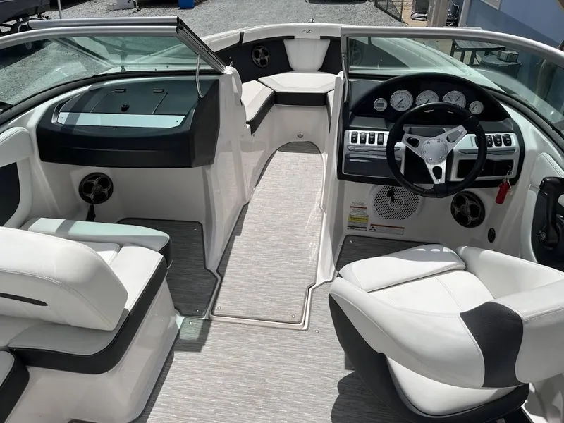 Slide: The Image of Interior of a 2016 Regal 2000 ESX boat with white seating and modern dashboard. - 12