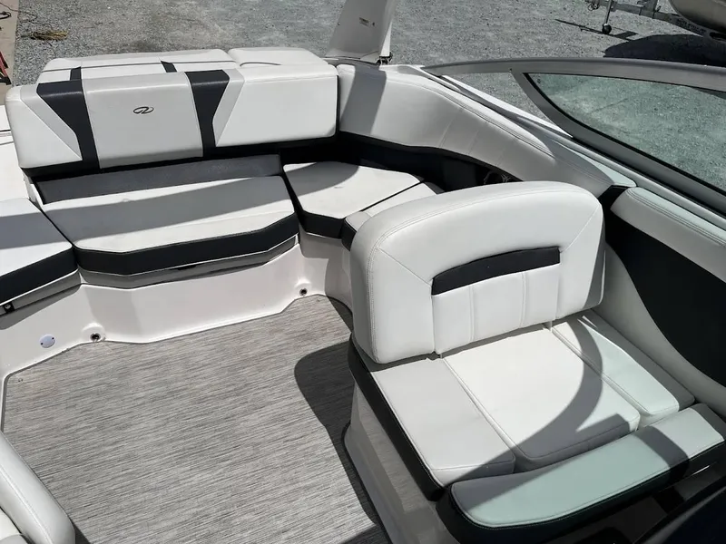 Slide: The Image of Interior seating of a 2016 Regal 2000 ESX boat, featuring white and black upholstery. - 13