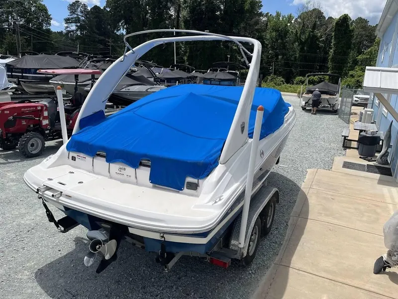Slide: The Image of 2016 Regal 2000 ESX boat with blue cover on trailer, parked outdoors. - 23