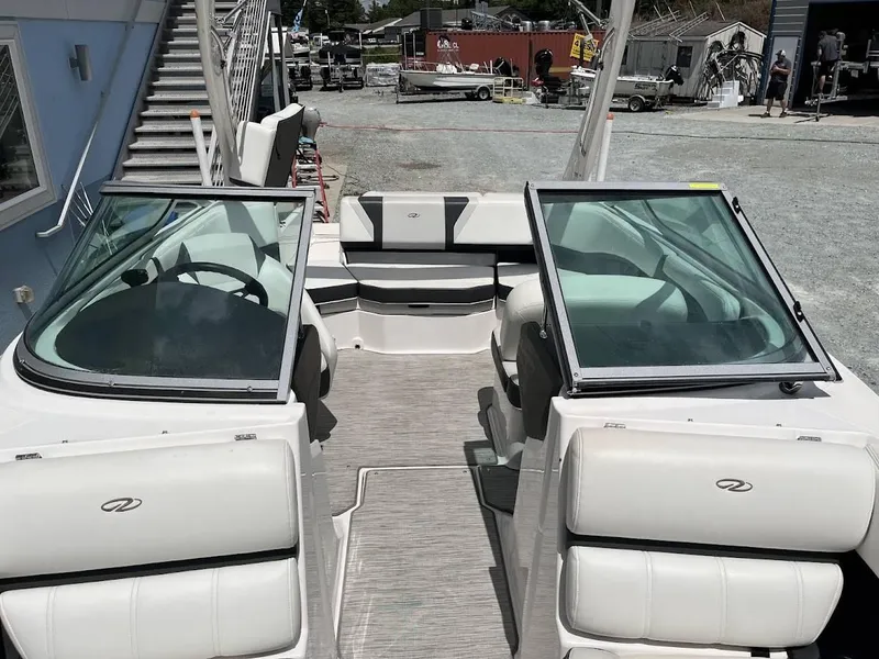 Slide: The Image of 2016 Regal 2000 ESX boat interior with dual consoles and seating, docked outdoors. - 5