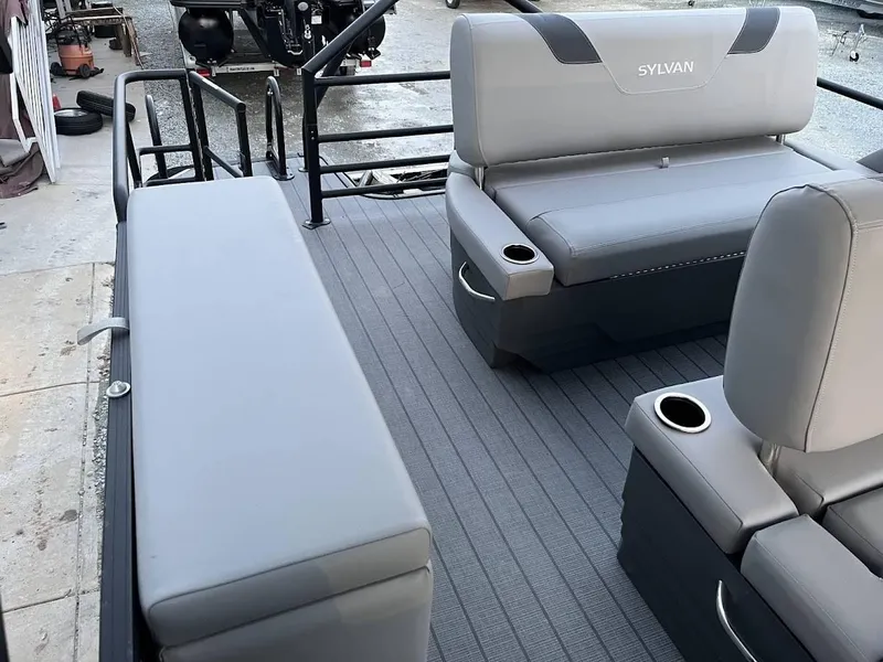 Slide: The Image of 2022 Sylvan L3 DLZ pontoon boat interior with gray seating and cup holders. - 10