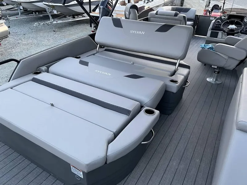 Slide: The Image of 2022 Sylvan L3 DLZ pontoon boat interior with gray seating and cup holders. - 12