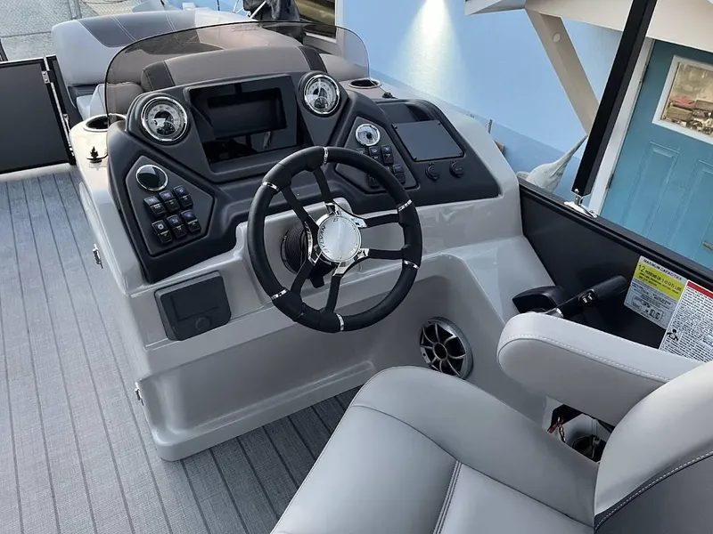 Slide: The Image of 2022 Sylvan L3 DLZ boat dashboard with steering wheel and control panel. - 14