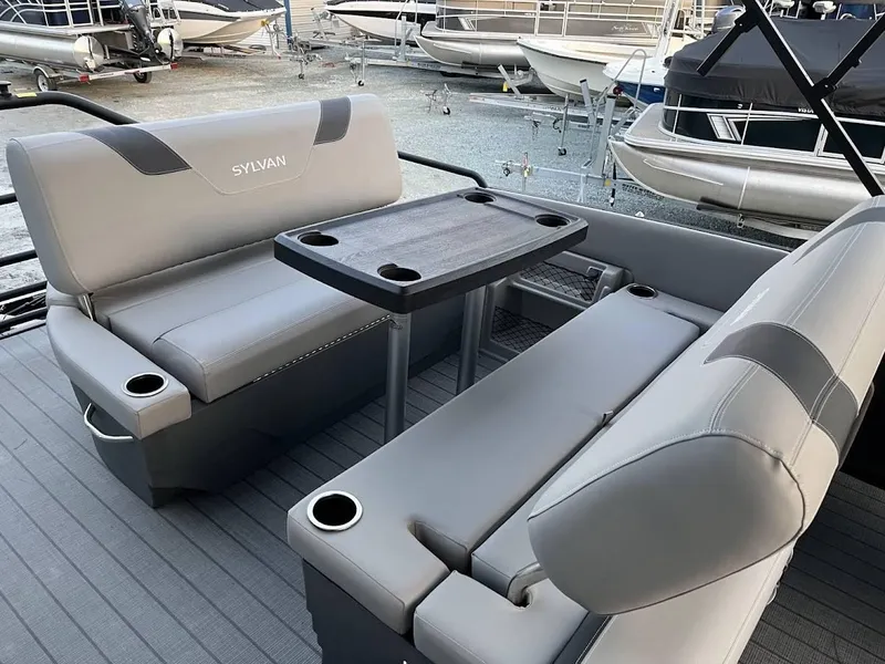 Slide: The Image of 2022 Sylvan L3 DLZ pontoon boat interior with gray seating and table. - 3