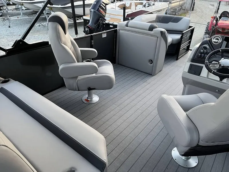 Slide: The Image of 2022 Sylvan L3 DLZ pontoon boat interior with gray seating and modern helm. - 4