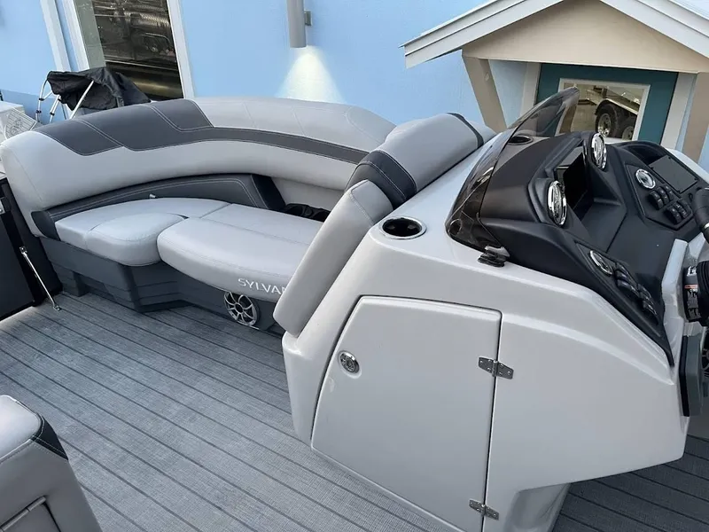 Slide: The Image of 2022 Sylvan L3 DLZ boat interior with sleek seating and modern dashboard design. - 6