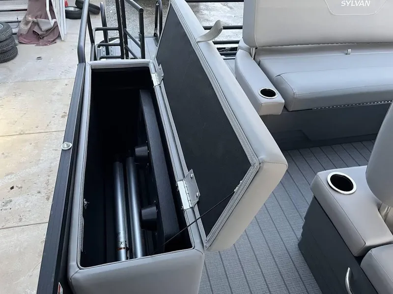 Slide: The Image of 2022 Sylvan L3 DLZ boat interior with open storage compartment and cup holders. - 9