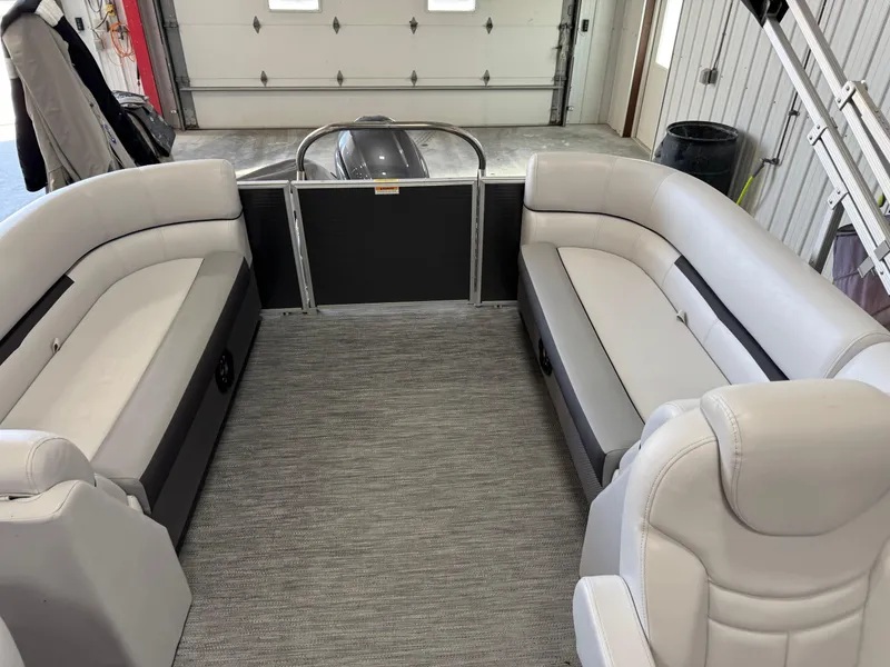 Slide: The Image of 2023 Sweetwater 2286 pontoon boat interior with gray seating and carpet. - 10