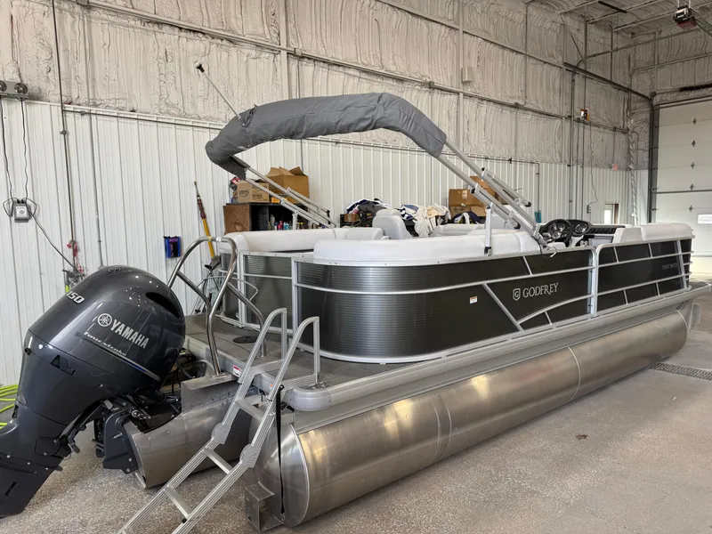 Slide: The Image of 2023 Sweetwater 2286 pontoon boat with Yamaha engine in a storage facility. - 12