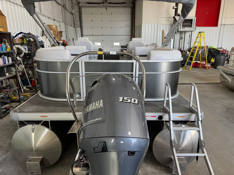 Slide: The Image of 2023 Sweetwater 2286 pontoon boat with Yamaha 150 engine in a garage setting. - 4