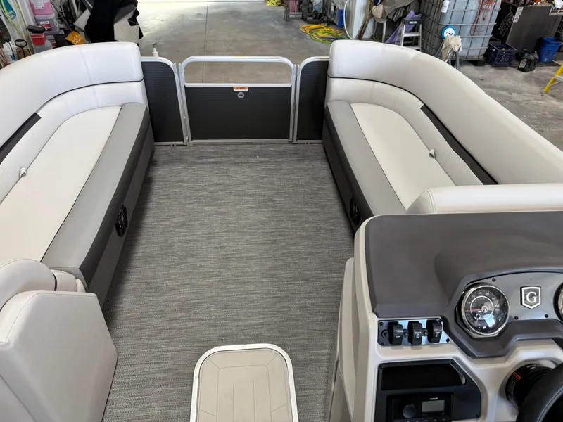 Slide: The Image of 2023 Sweetwater 2286 pontoon boat interior with spacious seating and modern dashboard. - 8