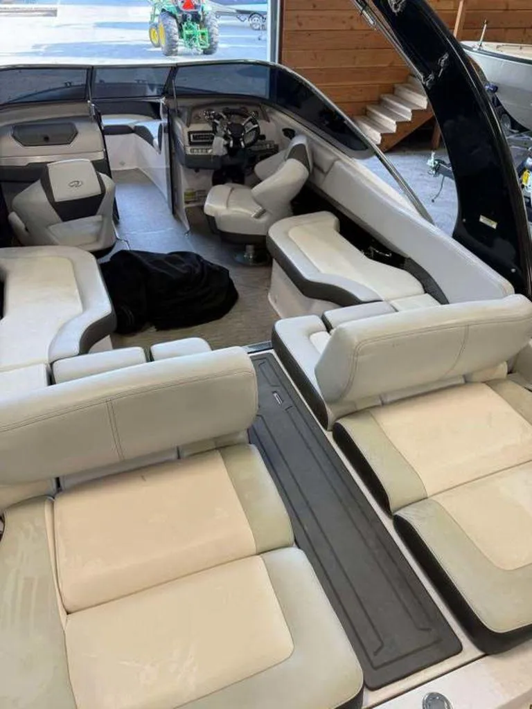 Slide: The Image of 2014 Regal 2300 boat interior with spacious seating and modern dashboard. - 11