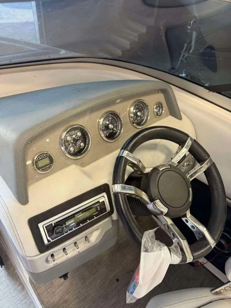 Slide: The Image of Dashboard of a 2014 Regal 2300 boat with steering wheel and gauges. - 4