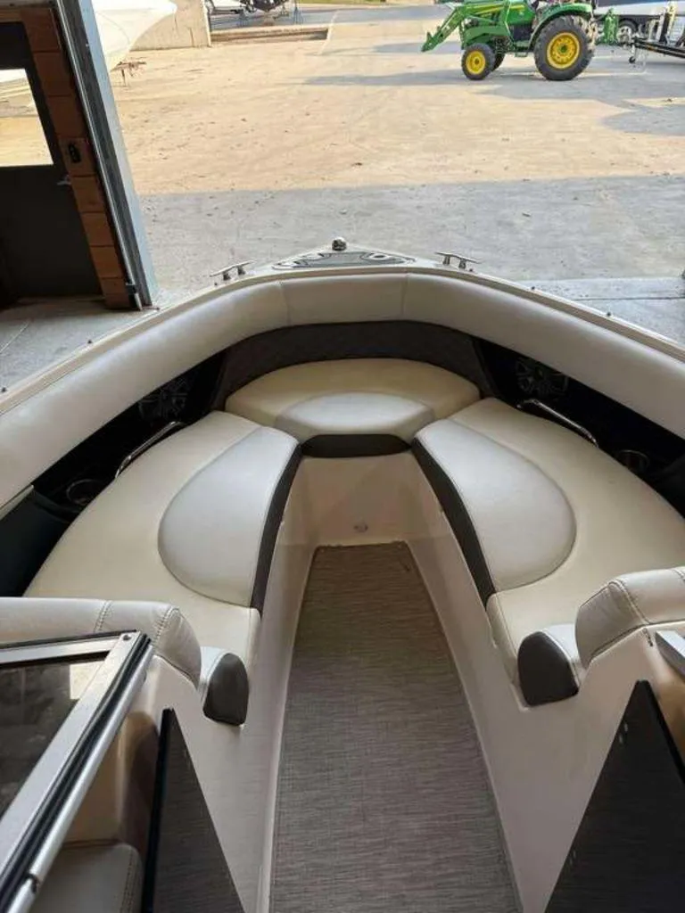 Slide: The Image of 2014 Regal 2300 boat interior with beige seating and carpeted floor. - 5