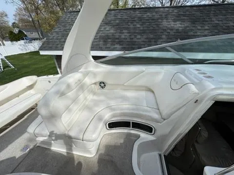 Slide: The Image of 2003 Sea Ray 280 Sundancer boat interior with white seating and dashboard. - 10