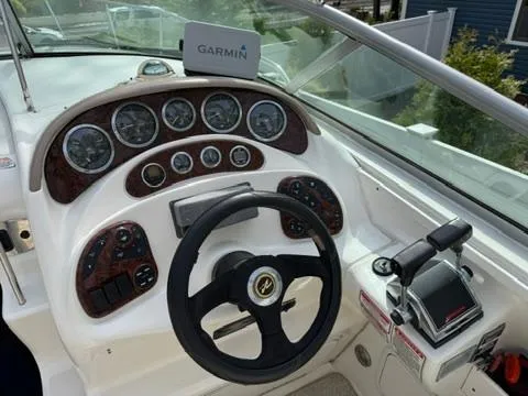 Slide: The Image of Helm of 2003 Sea Ray 280 Sundancer with Garmin navigation system and control panel. - 12