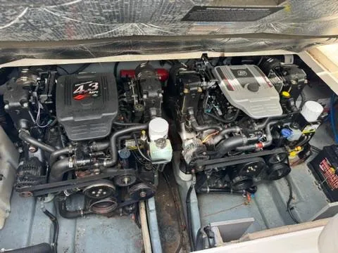 Slide: The Image of Twin engines of a 2003 Sea Ray 280 Sundancer boat, showcasing detailed mechanical components. - 23