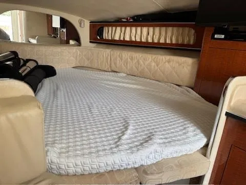 Slide: The Image of Interior cabin of 2003 Sea Ray 280 Sundancer with bed and wooden cabinetry. - 6