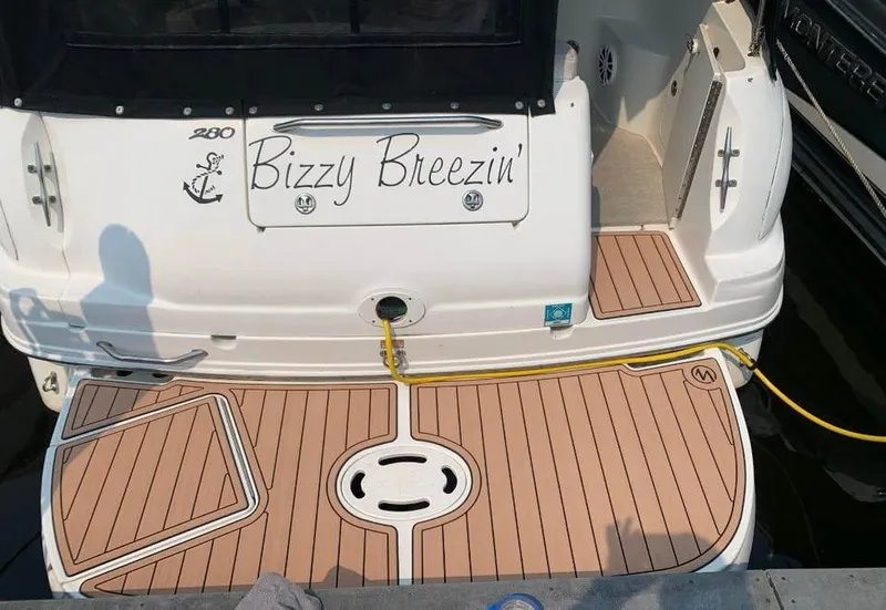 Slide: The Image of 2003 Sea Ray 280 Sundancer boat with "Bizzy Breezin'" name on the stern. - 7