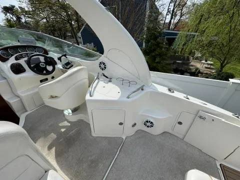 Slide: The Image of 2003 Sea Ray 280 Sundancer boat interior with steering wheel and control panel. - 9