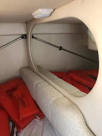 Slide: The Image of 2001 Sea Ray 260DA cabin interior with life jackets and mirror. - 11