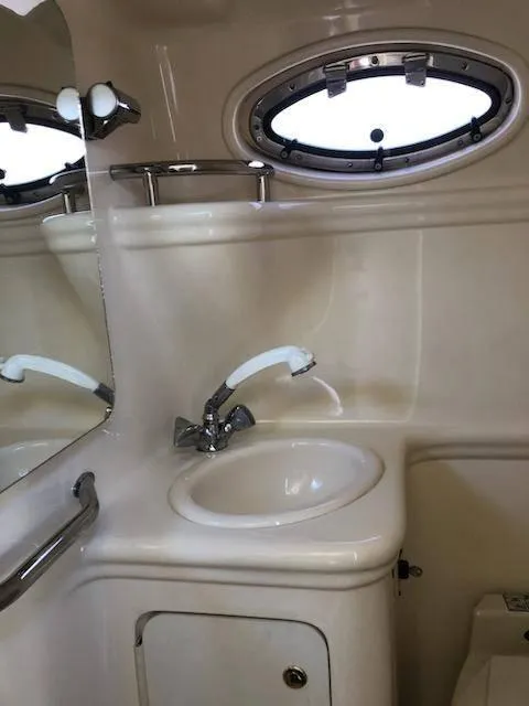 Slide: The Image of 2001 Sea Ray 260DA boat bathroom with sink and porthole window. - 15