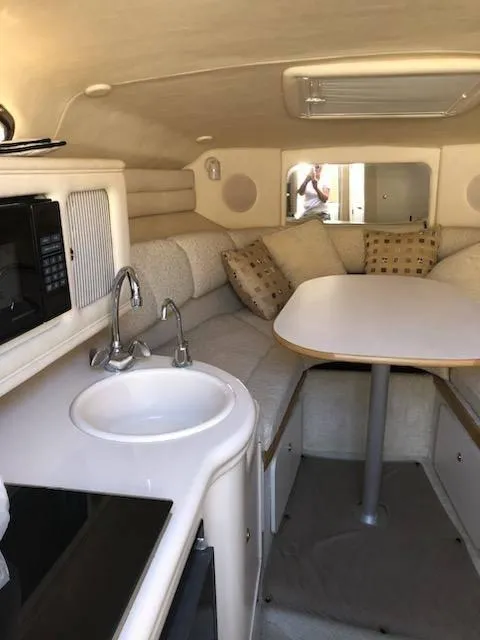 Slide: The Image of Interior of 2001 Sea Ray 260DA boat with kitchenette and seating area. - 21