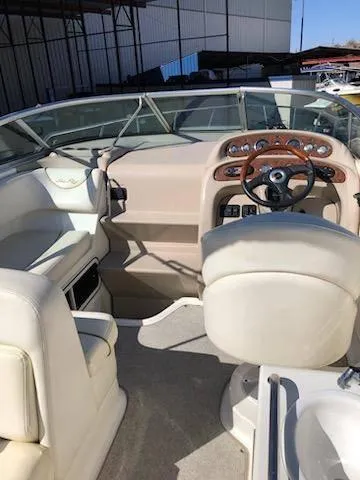 Slide: The Image of 2001 Sea Ray 260DA boat interior with steering wheel and seating. - 6